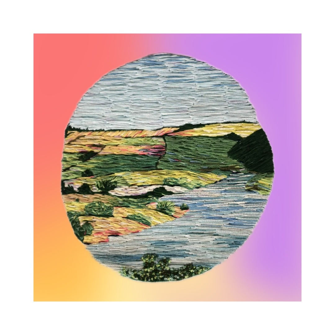 patchwork embroidery of a landscape in blues and greens